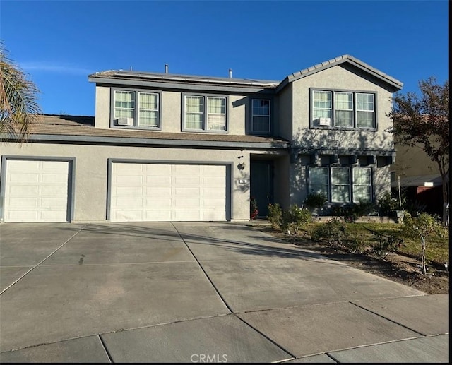 front of property featuring solar panels and a garage