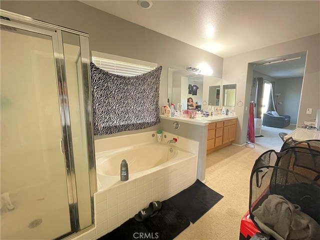 bathroom with shower with separate bathtub and vanity