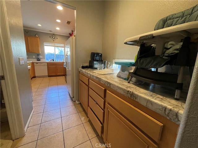 kitchen featuring white dishwasher, crown molding, and light tile patterned flooring