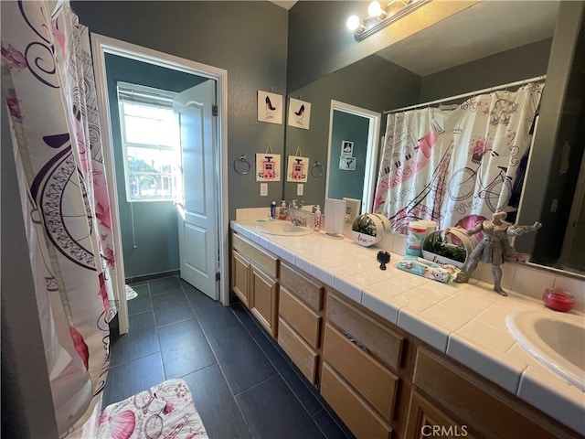 bathroom with tile patterned flooring and vanity