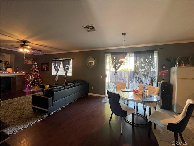 dining space with hardwood / wood-style flooring, ceiling fan, and ornamental molding