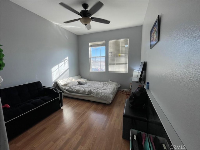 bedroom with hardwood / wood-style flooring and ceiling fan