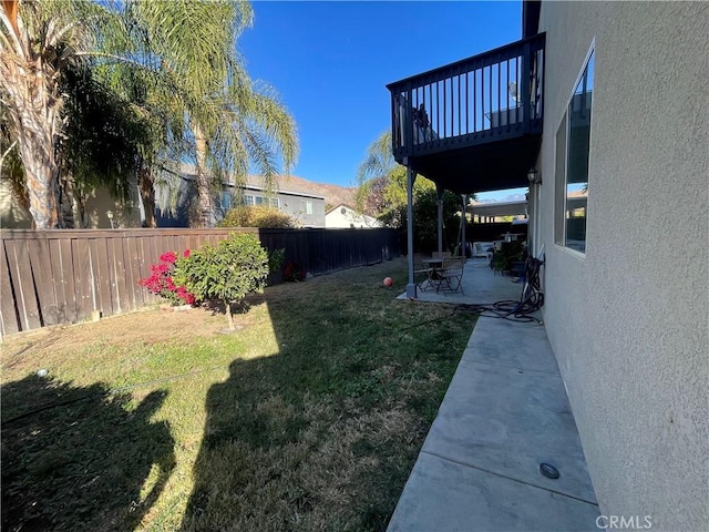 view of yard with a patio area and a deck