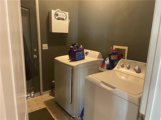 clothes washing area with washing machine and clothes dryer