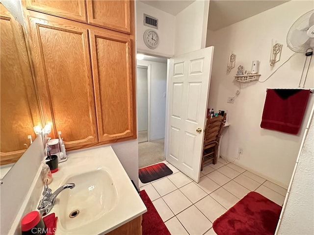 bathroom featuring tile patterned flooring and vanity