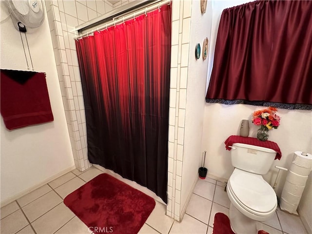 bathroom featuring tile patterned floors, toilet, and walk in shower