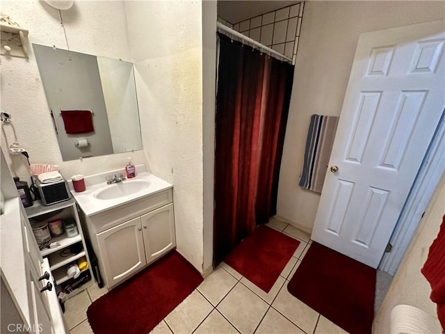 bathroom with tile patterned flooring and vanity