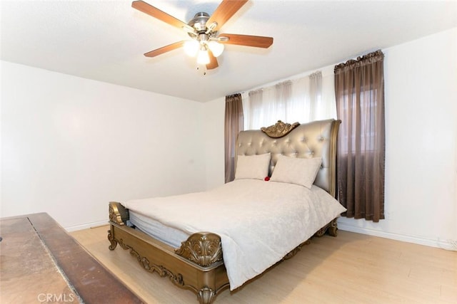 bedroom featuring ceiling fan and light hardwood / wood-style flooring