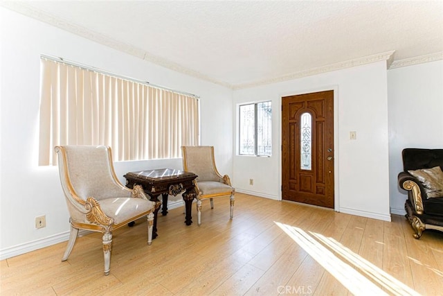 1748 N Kenmore Ave Unit 203, Los Angeles, CA 90027 - foyer featuring light wood-type flooring, crown molding, and baseboards
