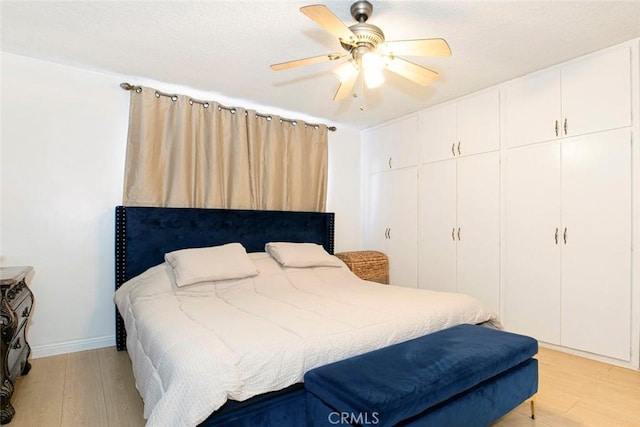 bedroom featuring ceiling fan and light hardwood / wood-style flooring