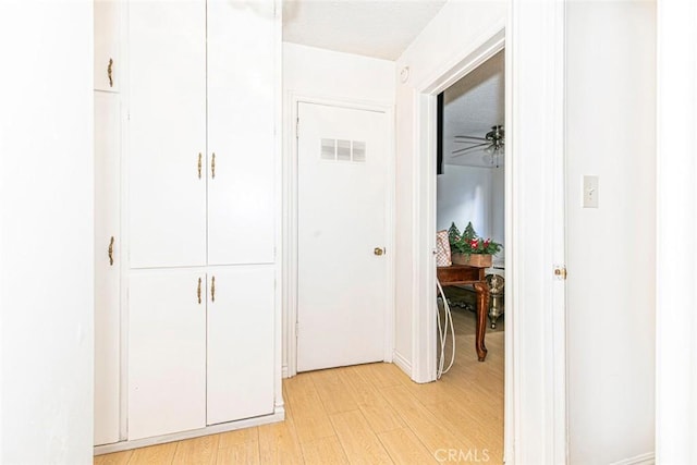 corridor with light hardwood / wood-style flooring