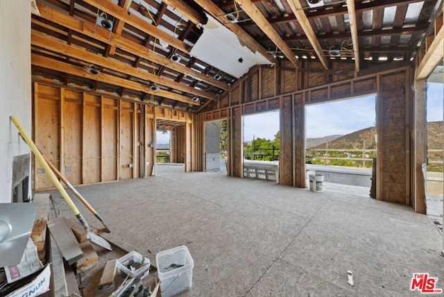 miscellaneous room with a mountain view and vaulted ceiling