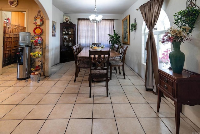 tiled dining area with an inviting chandelier