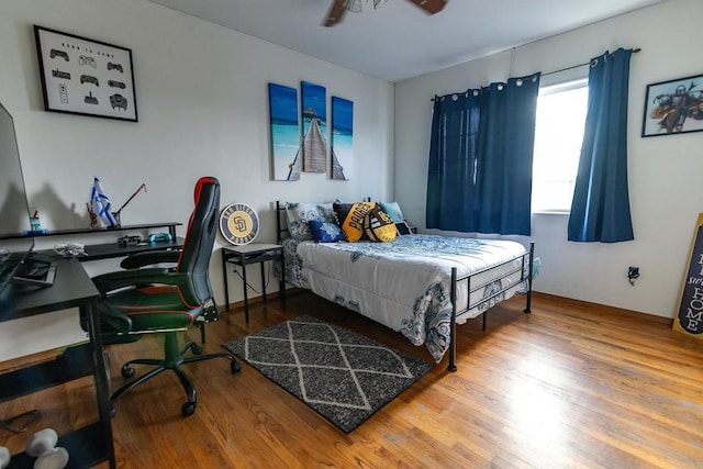 bedroom with ceiling fan and hardwood / wood-style floors