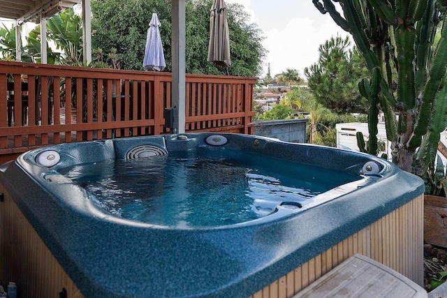 wooden deck featuring a hot tub