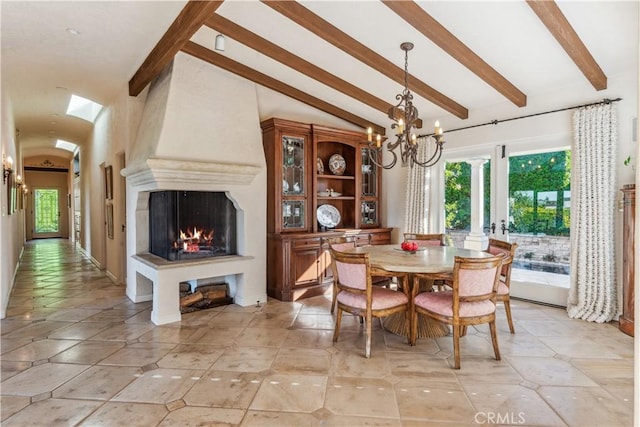 dining room with vaulted ceiling with beams, a fireplace, and a notable chandelier