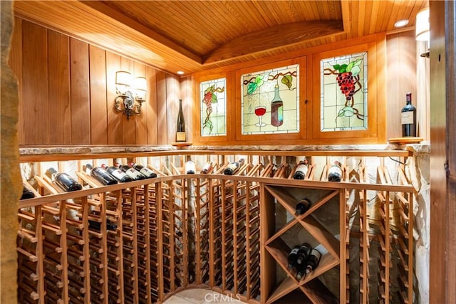 wine room with wooden walls, wooden ceiling, and vaulted ceiling