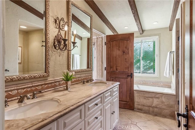 bathroom with tiled tub, tile patterned flooring, vanity, and beamed ceiling