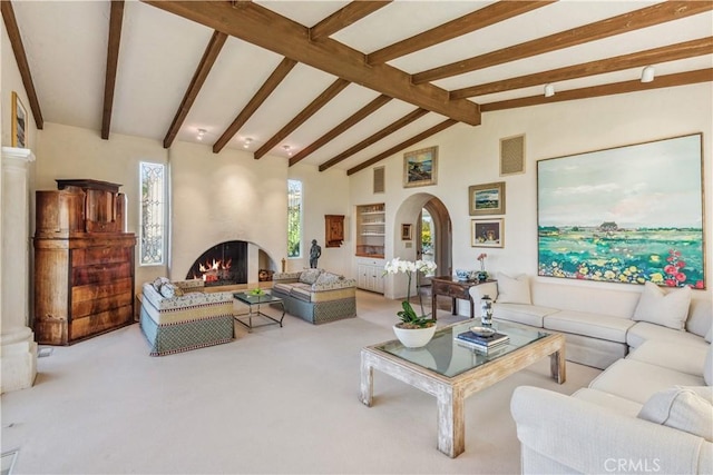 living room featuring beam ceiling, light carpet, a large fireplace, and high vaulted ceiling