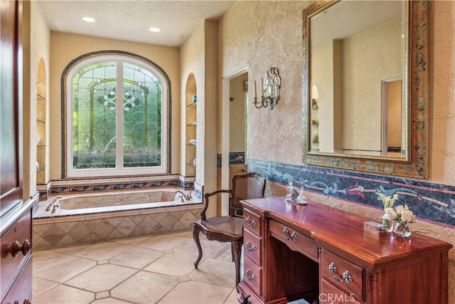 bathroom featuring tile patterned floors and tiled bath