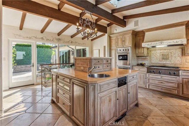 kitchen featuring decorative backsplash, custom range hood, stainless steel appliances, sink, and an island with sink