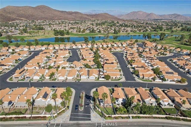 drone / aerial view with a water and mountain view