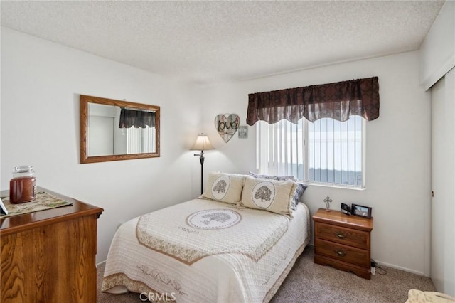 carpeted bedroom featuring a textured ceiling