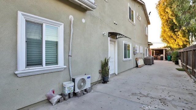 view of side of property with ac unit, central AC unit, and a patio area