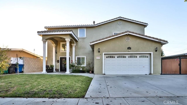 mediterranean / spanish-style home with a front yard and a garage