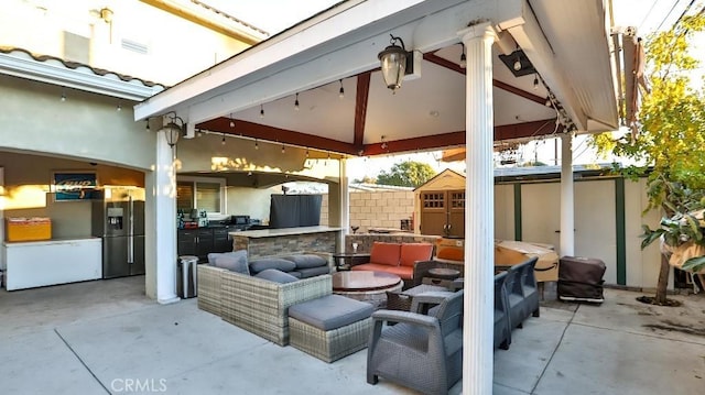 view of patio featuring a gazebo and a storage unit