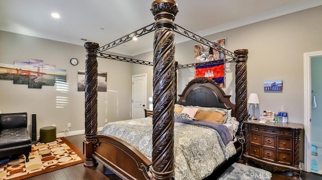 bedroom with ornamental molding and hardwood / wood-style flooring