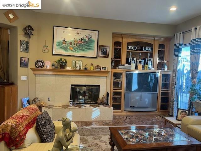 living room featuring a tile fireplace