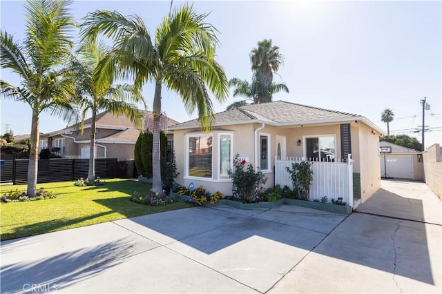 single story home with a front yard, an outbuilding, and a garage