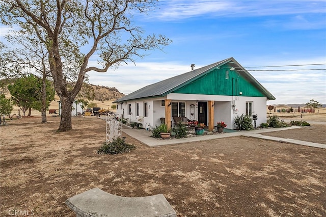 view of front of house with a porch and a mountain view