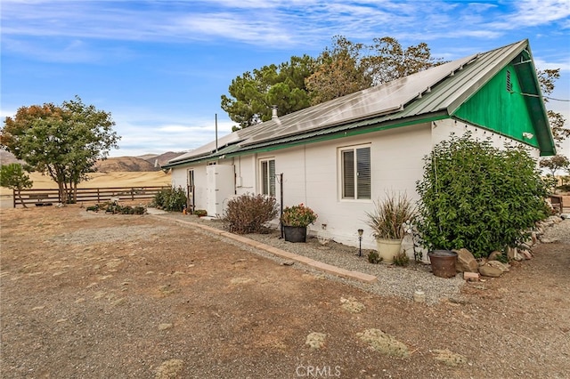 view of property exterior with solar panels