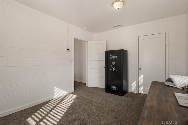 unfurnished office featuring dark colored carpet and crown molding