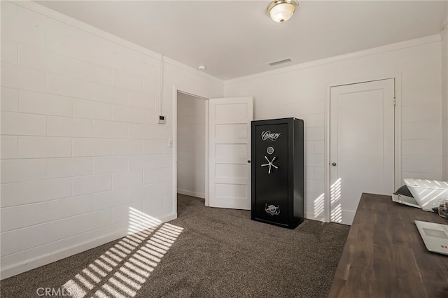 bedroom featuring visible vents, crown molding, and dark carpet