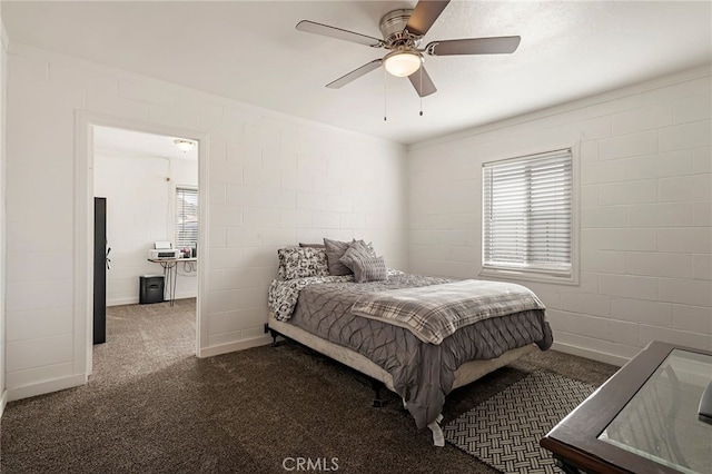 bedroom featuring ceiling fan and dark carpet