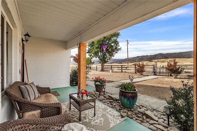 view of patio with a rural view and a mountain view