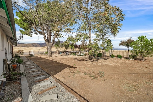 view of yard with a rural view and a mountain view