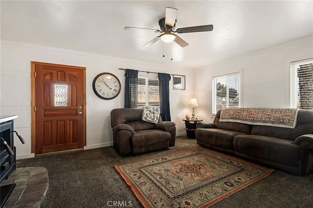 carpeted living room featuring ceiling fan and ornamental molding