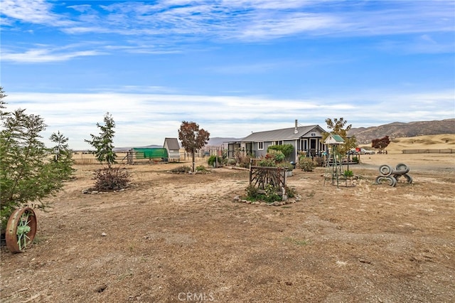 view of yard featuring a rural view and a mountain view