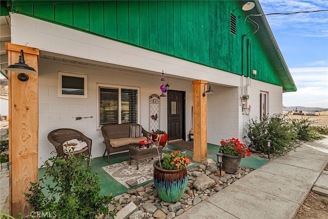 exterior space with concrete block siding and covered porch