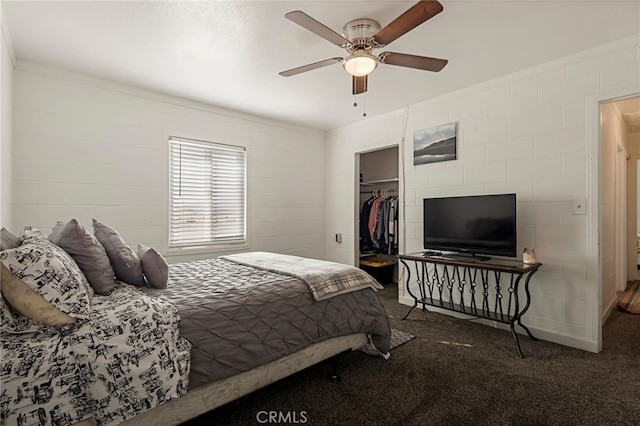 carpeted bedroom with a closet, ceiling fan, and a spacious closet