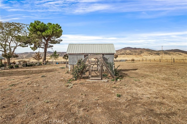 view of outdoor structure featuring a rural view and a mountain view