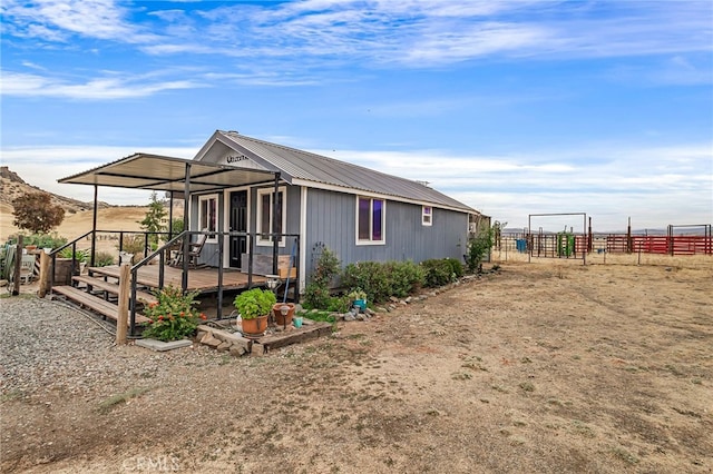 view of front of property featuring a deck with mountain view