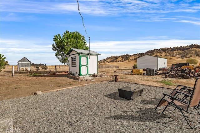 view of yard featuring a storage shed and a mountain view