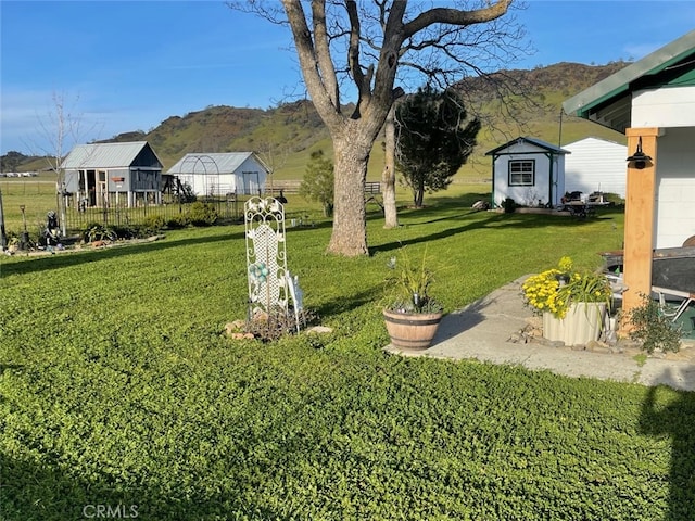 view of yard with a shed and a mountain view