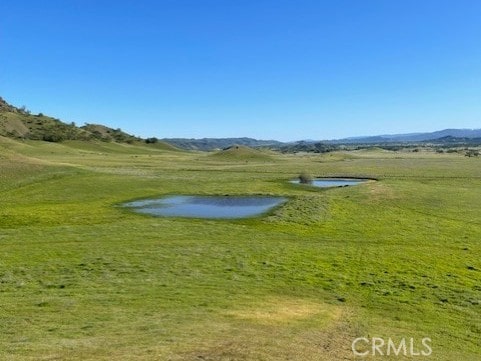 surrounding community featuring a yard and a water view