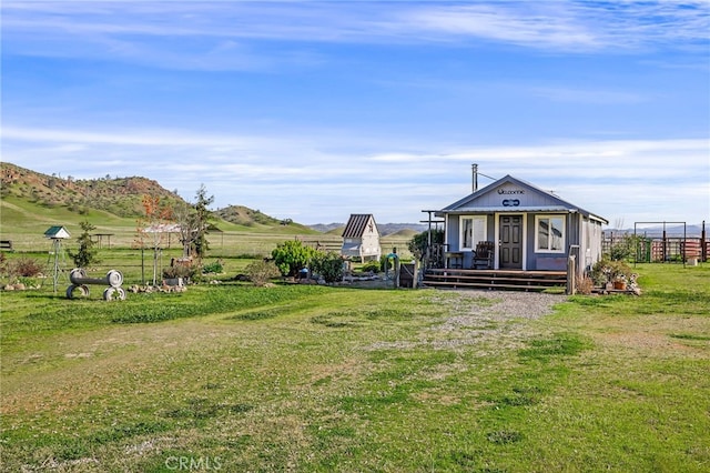 exterior space with a mountain view and fence